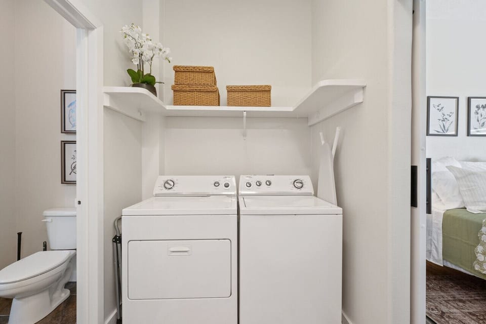 Charming laundry room stocked with all the essential appliances, ensuring a smooth and efficient washing experience.