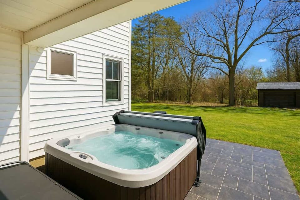 Private outdoor hot tub tucked beside the home, perfect for relaxing under open skies