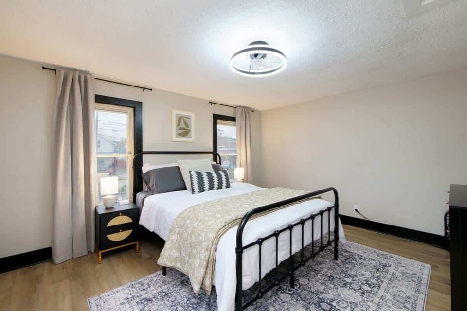 Calm bedroom retreat w/ soft bedding, warm lighting & a simple, relaxing design