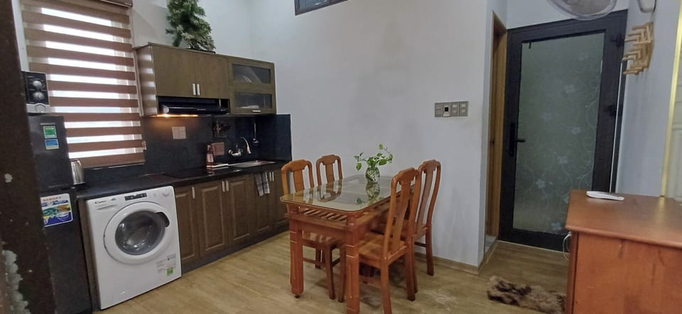 kitchen is full equipped electric stove, pan, stove, hook, utensil, microwave. .