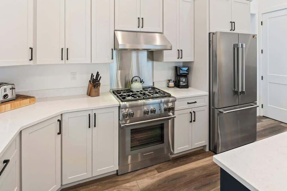 Spacious open kitchen featuring sleek stainless steel appliances.