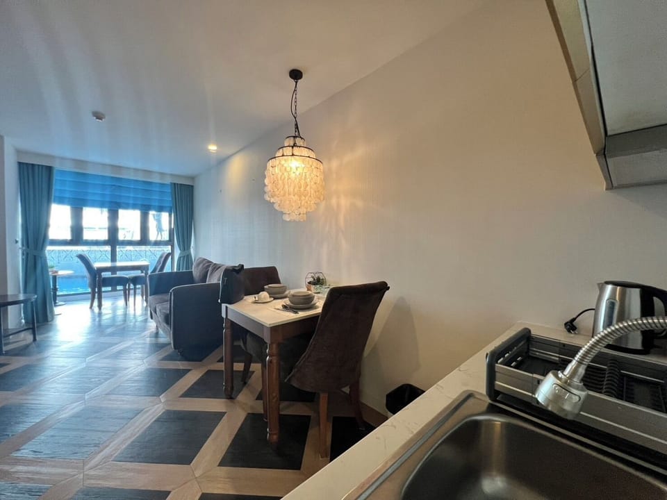 Deluxe Apartment, 1 Queen Bed, Ground Floor | In-room safe, desk, laptop workspace, iron/ironing board