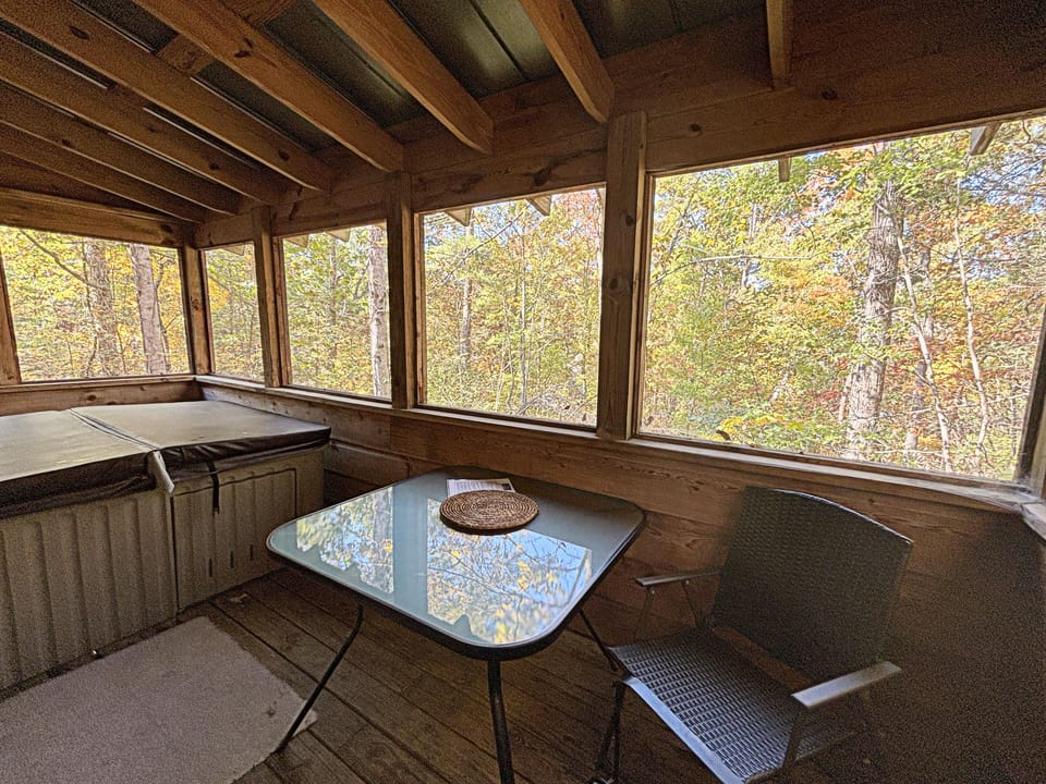 Hot Tub and seating on Screened in porch