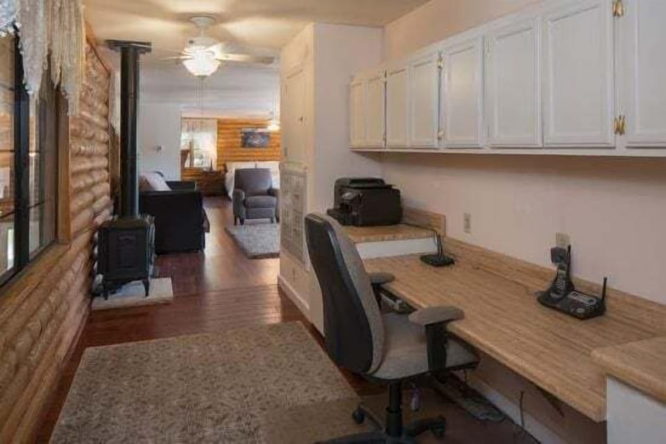 Master Suite: A lavish and exceptionally spacious environment with a King-sized bed, 2 Twin with Trundle beds (Room Sleeps 6), a massage chair, and a dedicated office workspace.