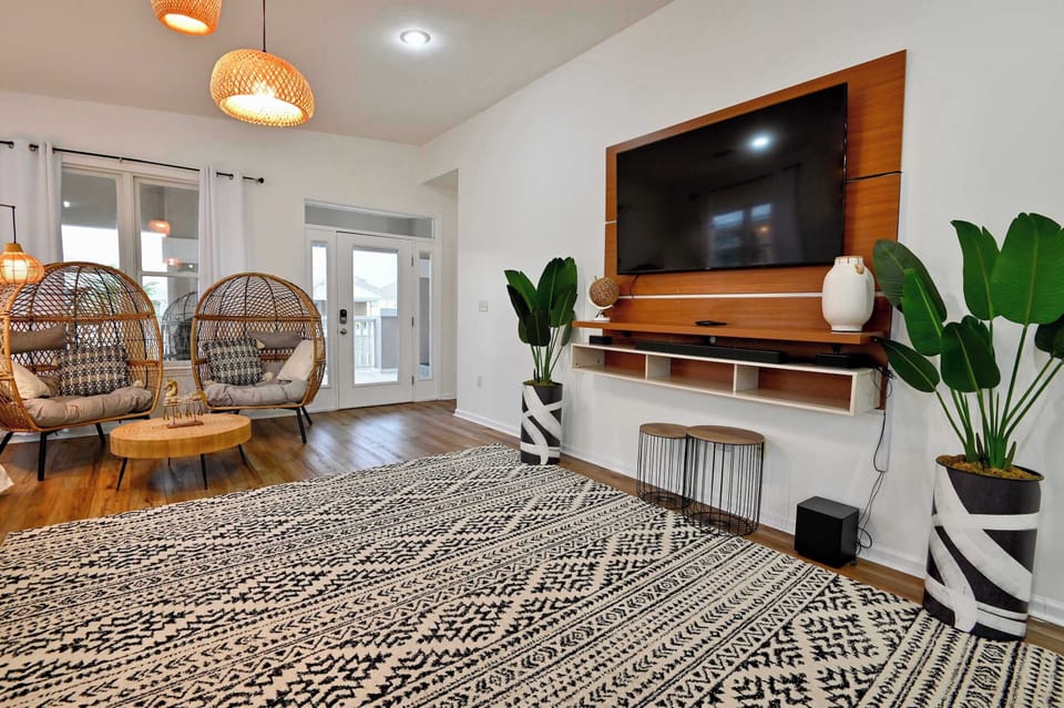 Bright living area with queen sofa sleeper, and Smart TV