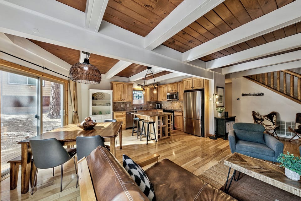 Relax in your rustic-chic retreat with soaring wood-beamed ceilings, a fully equipped kitchen, and cozy living space perfect for mountain getaways.