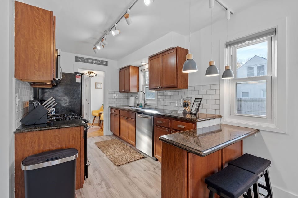 Your fully equipped kitchen features warm wood cabinets, granite counters, and modern appliances—perfect for preparing memorable meals during your stay.