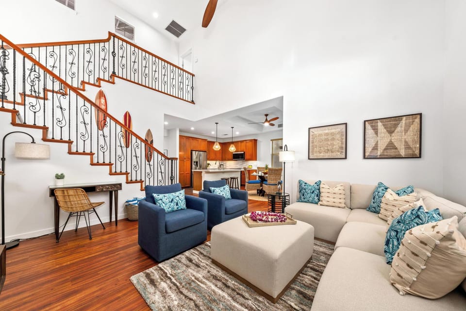 Spacious living room with vaulted ceilings and tall windows