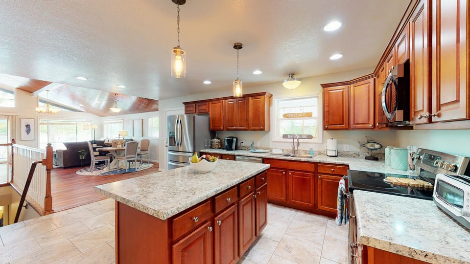 Large fully stocked kitchen open to the living room with lake views