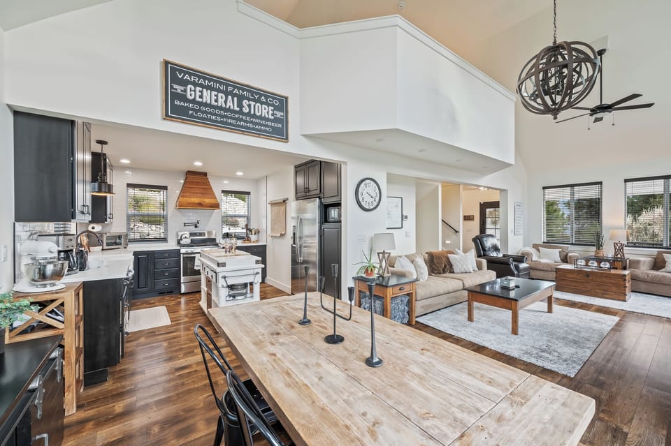 Open concept main living room, dining area and adjacent fully loaded kitchen