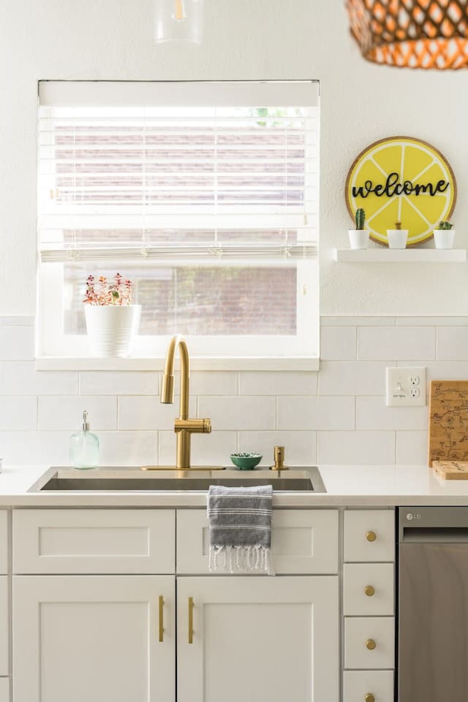 Kitchen window brings in natural light and cheerful charm.