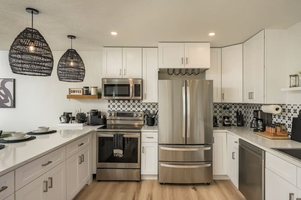 Fully stocked kitchen with gas stove, coffee bar, and modern finishes. Vrbo: Cook with ease in the updated kitchen featuring premium appliances.