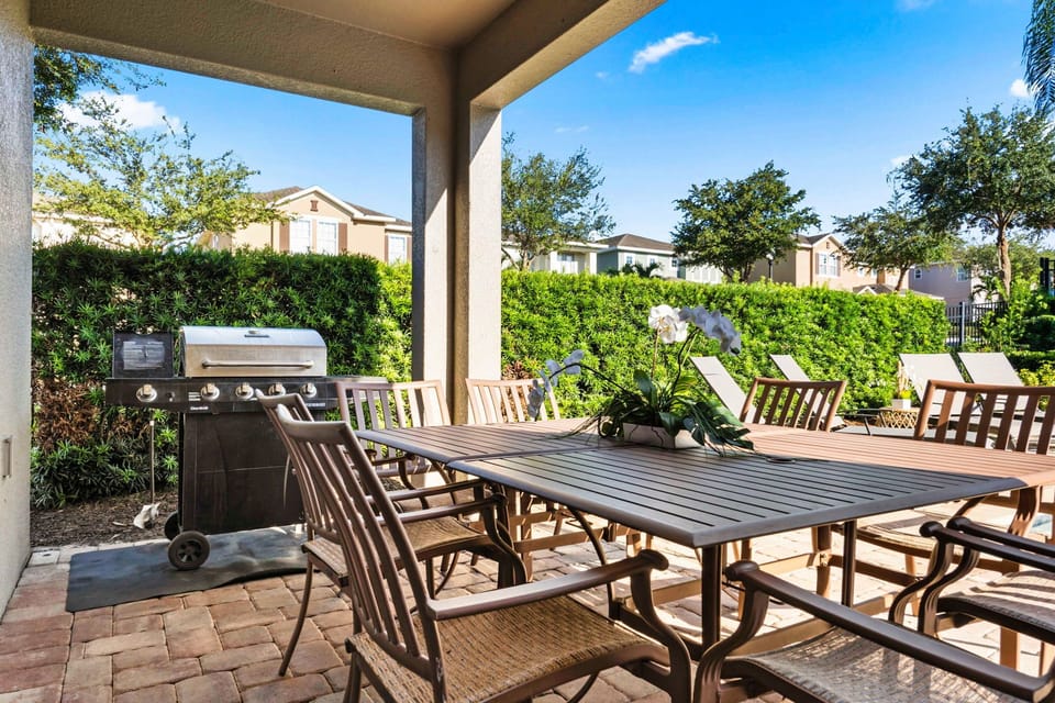Outdoor dining area with BBQ grill, perfect for al fresco meals and gatherings.