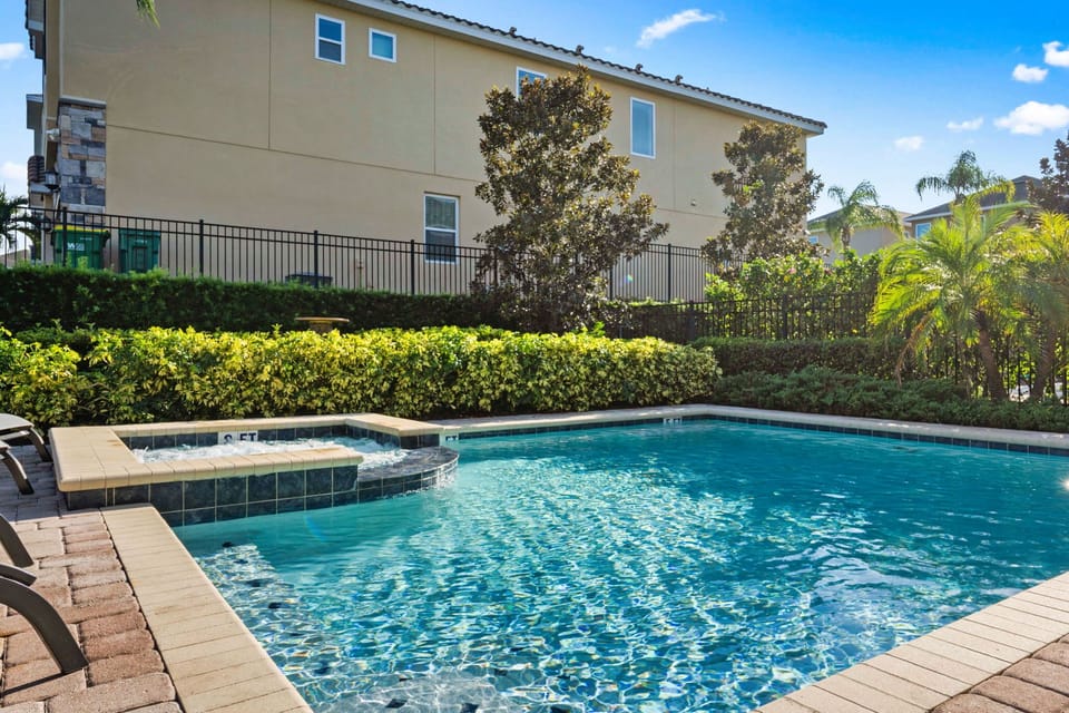 Large pool and luxurious spa for cooling off in the Florida sunshine.