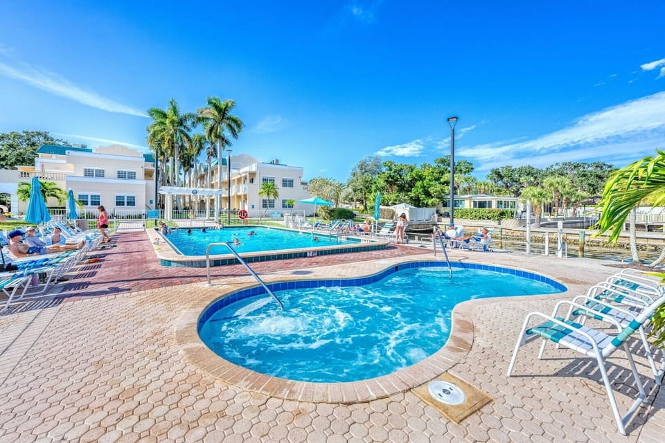 Jacuzzi area with adjacent pool for lounging.