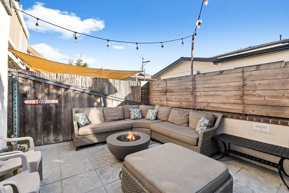 Experience the ultimate relaxation in this stylish patio space, complete with a warm fire pit and ample seating.