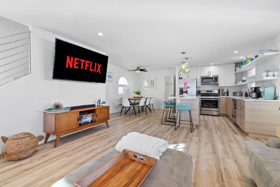 Create lasting memories in this open living space, featuring a modern kitchen, dining area, and inviting living room.