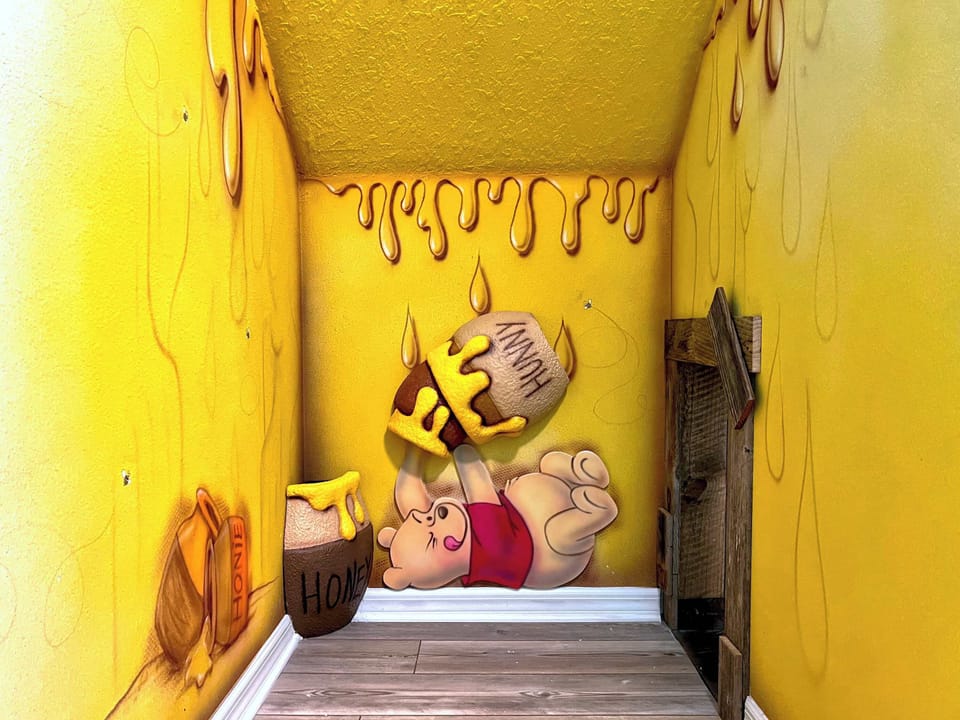 Enchanting Winnie the Pooh-themed kids' nook provides a fun and cozy retreat for reading, relaxing, or imaginative adventures.
