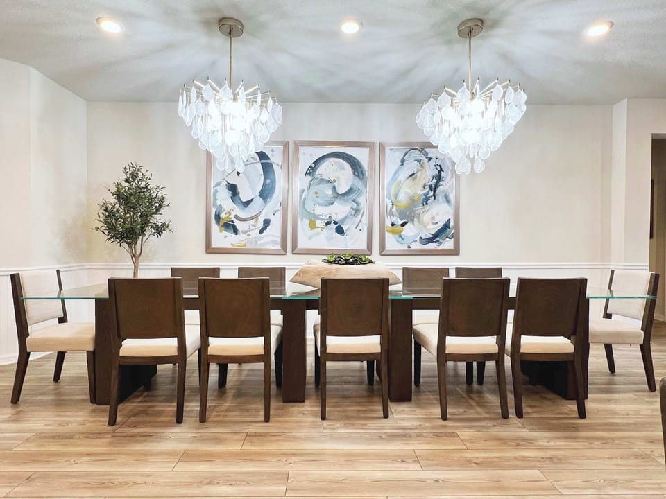 Open-concept chef's kitchen with stainless steel appliances, fully stocked cookware, dining for 12, and bar stool seating—perfect for family meals and entertaining.
