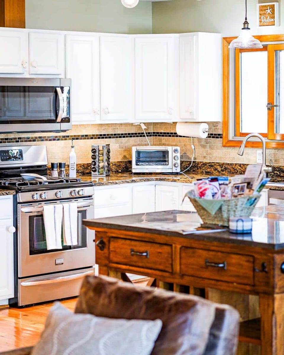 This kitchen has everything! Well equipped with an array of pots, pans, small appliances, a rice cooker, food processor, blender, cookie sheets, kitchen gadgets, and more. You can cook up a feast here!