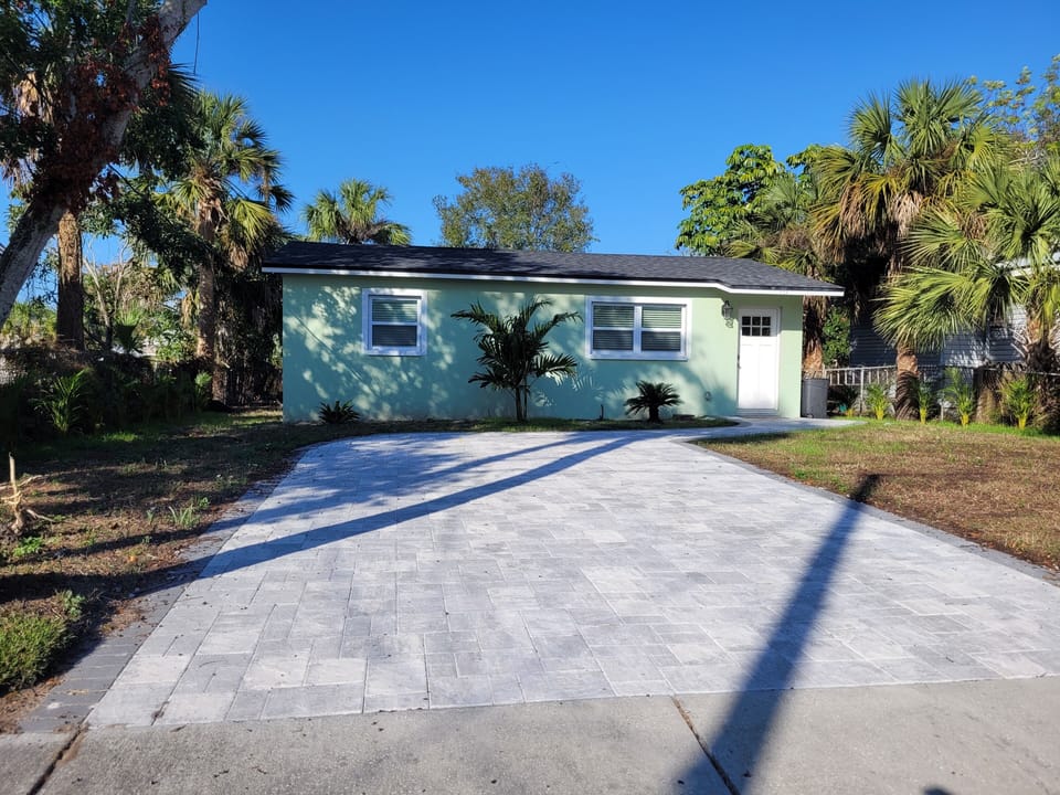 House has new large, wide paver driveway