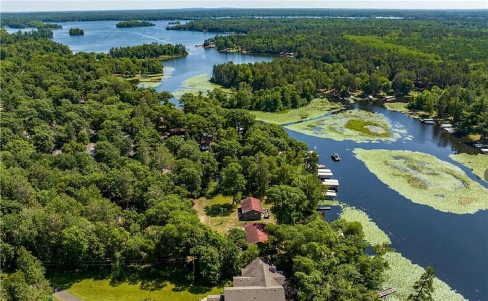 High-angle bird`s eye view of the lake and surrounding forest.