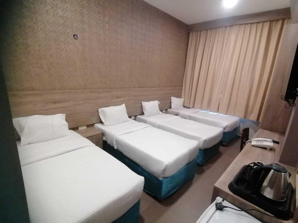 Basic Quadruple Room | Hypo-allergenic bedding, pillowtop beds, in-room safe, blackout drapes