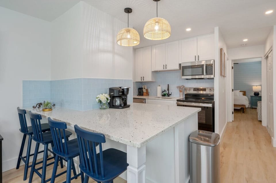 Chic chairs and a modern countertop create a perfect gathering spot.