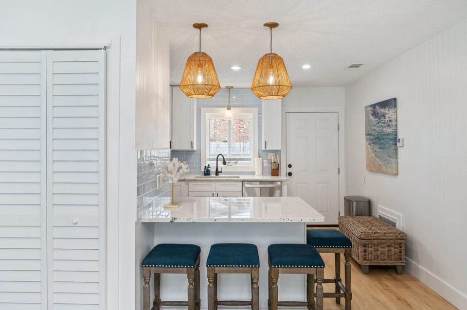 Chic chairs and a modern countertop create a perfect gathering spot.