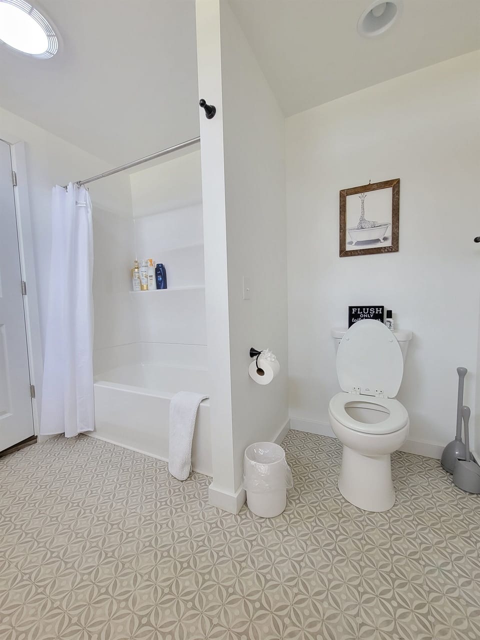 Full shower and tub and the toilet in the Jack & Jill bathroom