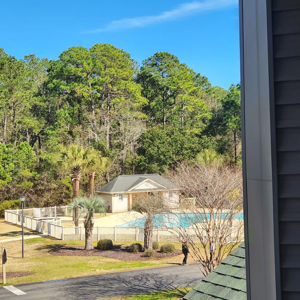 pool and hot tub direcly across parking area from condo