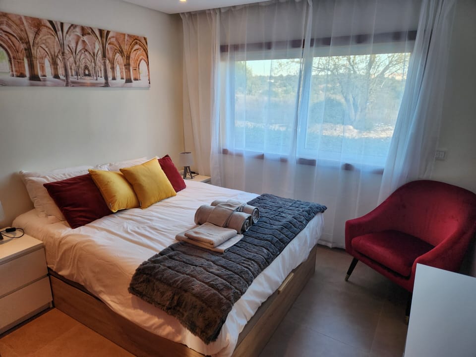 Main floor queen bed guest room – cozy and convenient for a restful stay