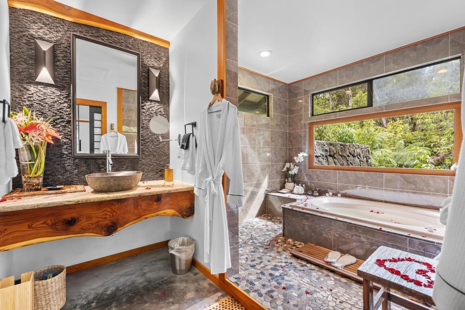 Luxurious rainforest spa bath with scenic views.