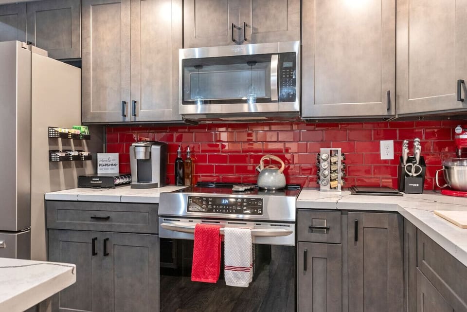 Kitchen - Main Level - Fully stocked, Red Glass Tile Backsplash, Stainless Steel Appliances, Quartz Countertops!