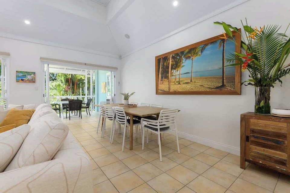 Expansive dining area featuring an 8-seater dining table that seamlessly extends out to a private balcony.  It's the perfect setup for entertaining guests or enjoying a meal with a view!