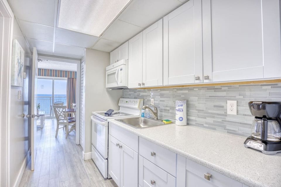 Kitchen: Modern appliances and beach views set the perfect stage for culinary adventures!