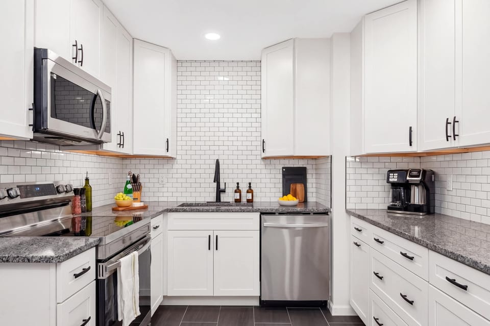 Modern culinary bliss. ✨ Enjoy a pristine kitchen featuring subway tile accents, stainless steel essentials, and all the tools needed for a perfect stay.