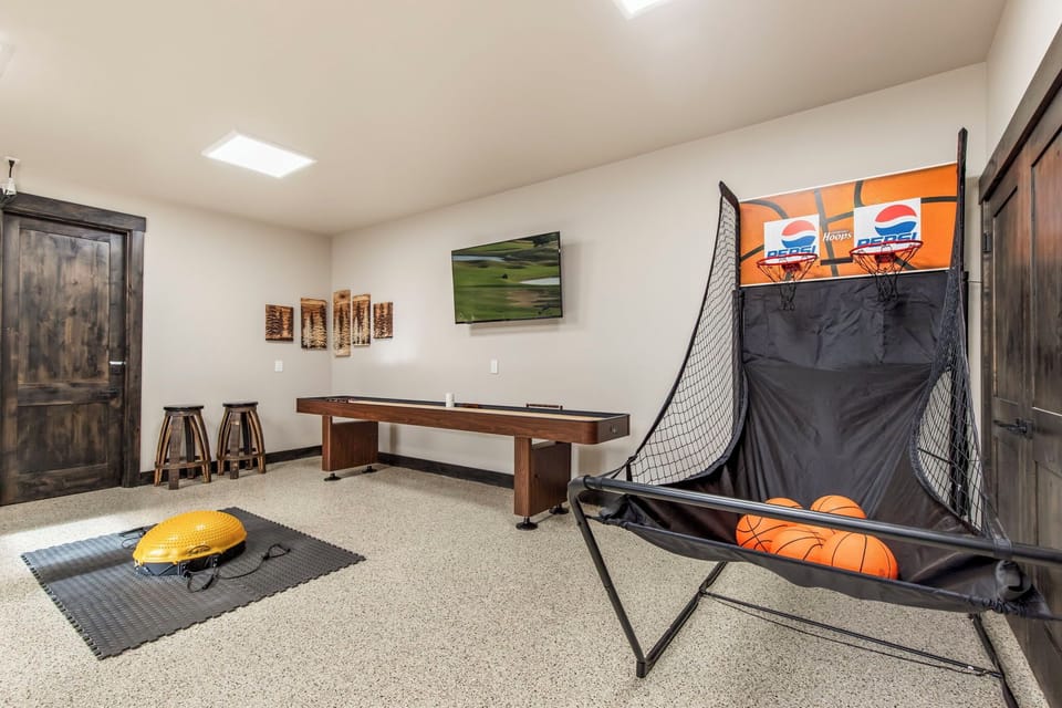 Game room lounge — bean bags, 60" Smart TV, cornhole & axe throw set
