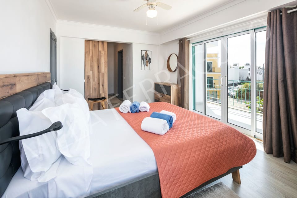 Elegant master bedroom in Villa Ferragudo with private terrace access.
