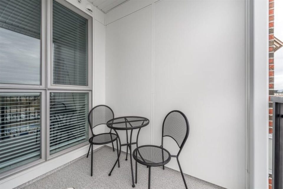 Private covered outdoor balcony featuring table seating.