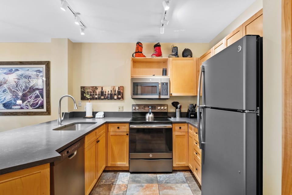 Prepare your favorite meals in this fully equipped kitchen featuring stainless steel appliances, sleek countertops, and everything you need.