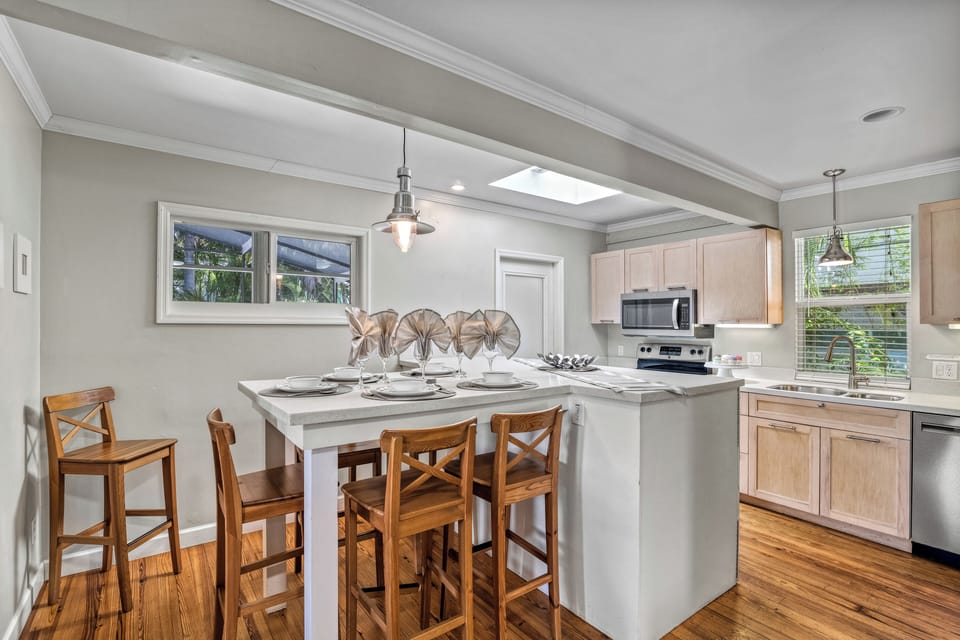 Gather around the wide dining bar for morning mimosas or late-night laughs—the heart of the home flows seamlessly from kitchen to conversation.