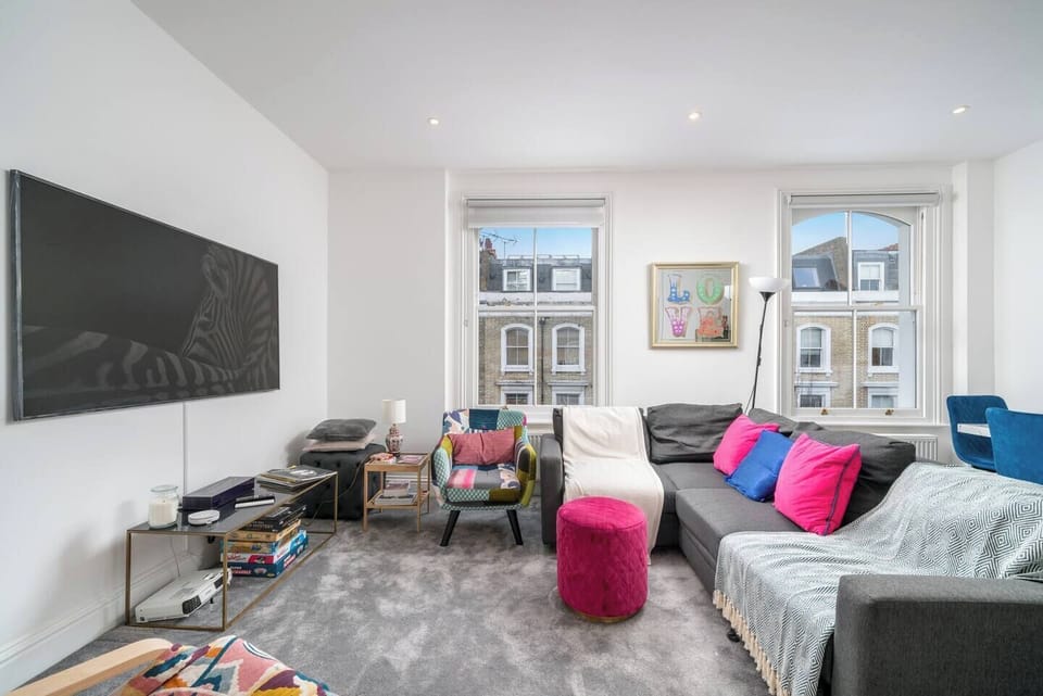 Step into this cozy and well-arranged living room, featuring a comfortable couch that invites relaxation. The couch is adorned with soft pillows, setting the stage for a perfect entertainment area.