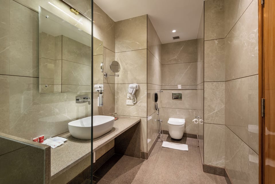 Deluxe Room, City View | Bathroom | Shower, slippers, towels, toilet paper