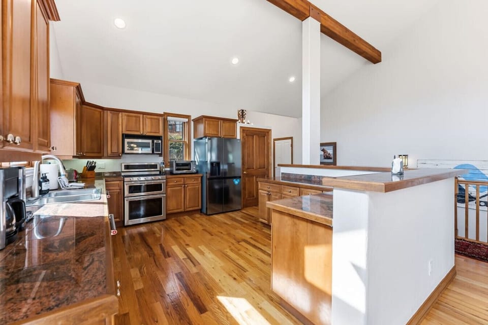 Chef’s kitchen with granite counters and modern appliances