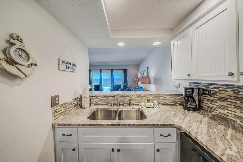 The fully equipped kitchen features granite countertops, updated cabinets & appliances, and has everything you need to prepare meals for family & friends.