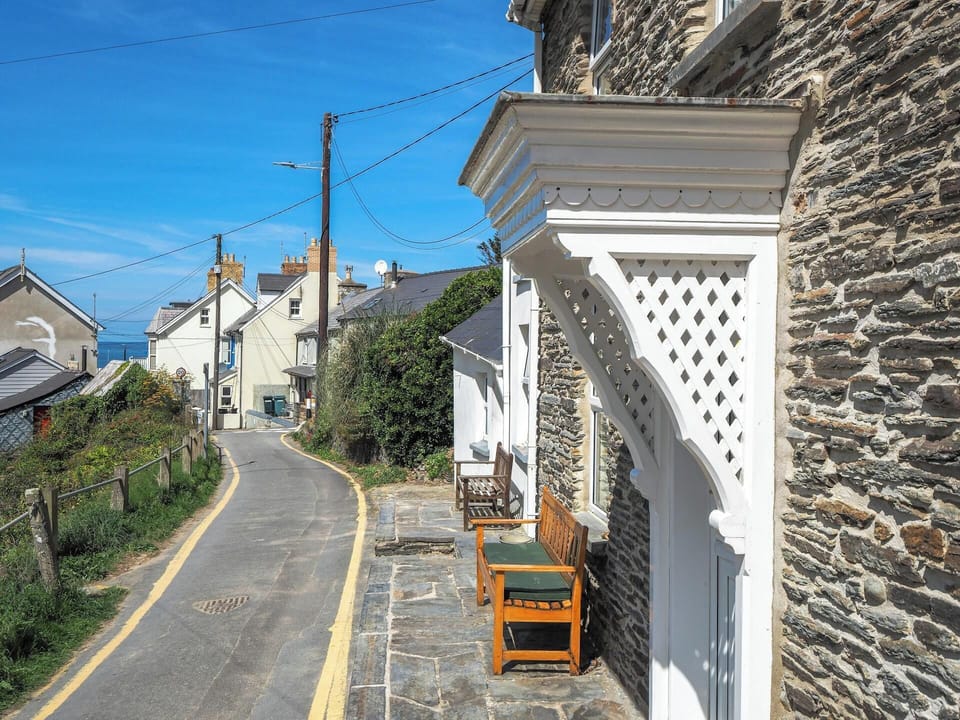 View across front of Bywell showing the road leading to the beach and a distant sea view