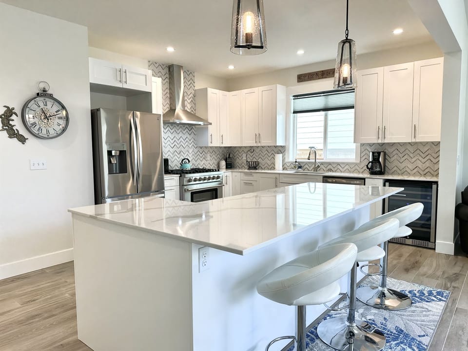 Sip wine and share stories in the large kitchen with quartz island.