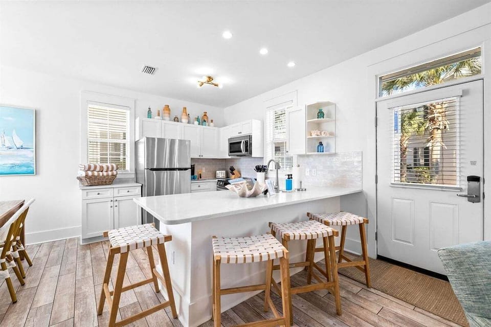 Gather 4 around the island in the bright and open kitchen
