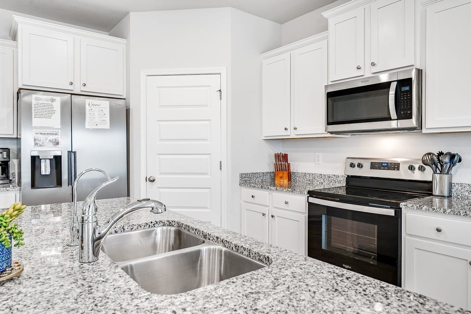 You'll love cooking in this bright, modern kitchen with granite counters, stainless appliances, and everything needed for your culinary adventures.
